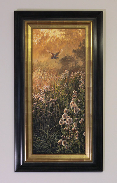 Framed oil painting of a barn owl in flight.